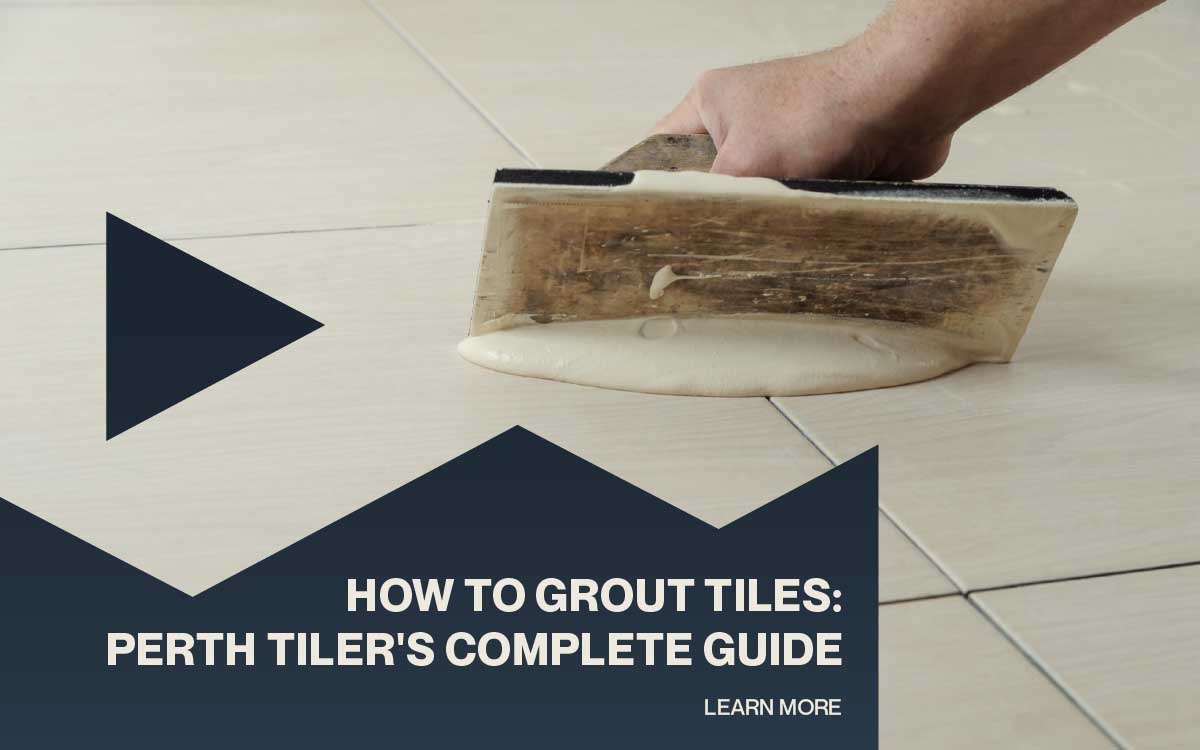 Hand applying grout between floor tiles during a tile installation project.